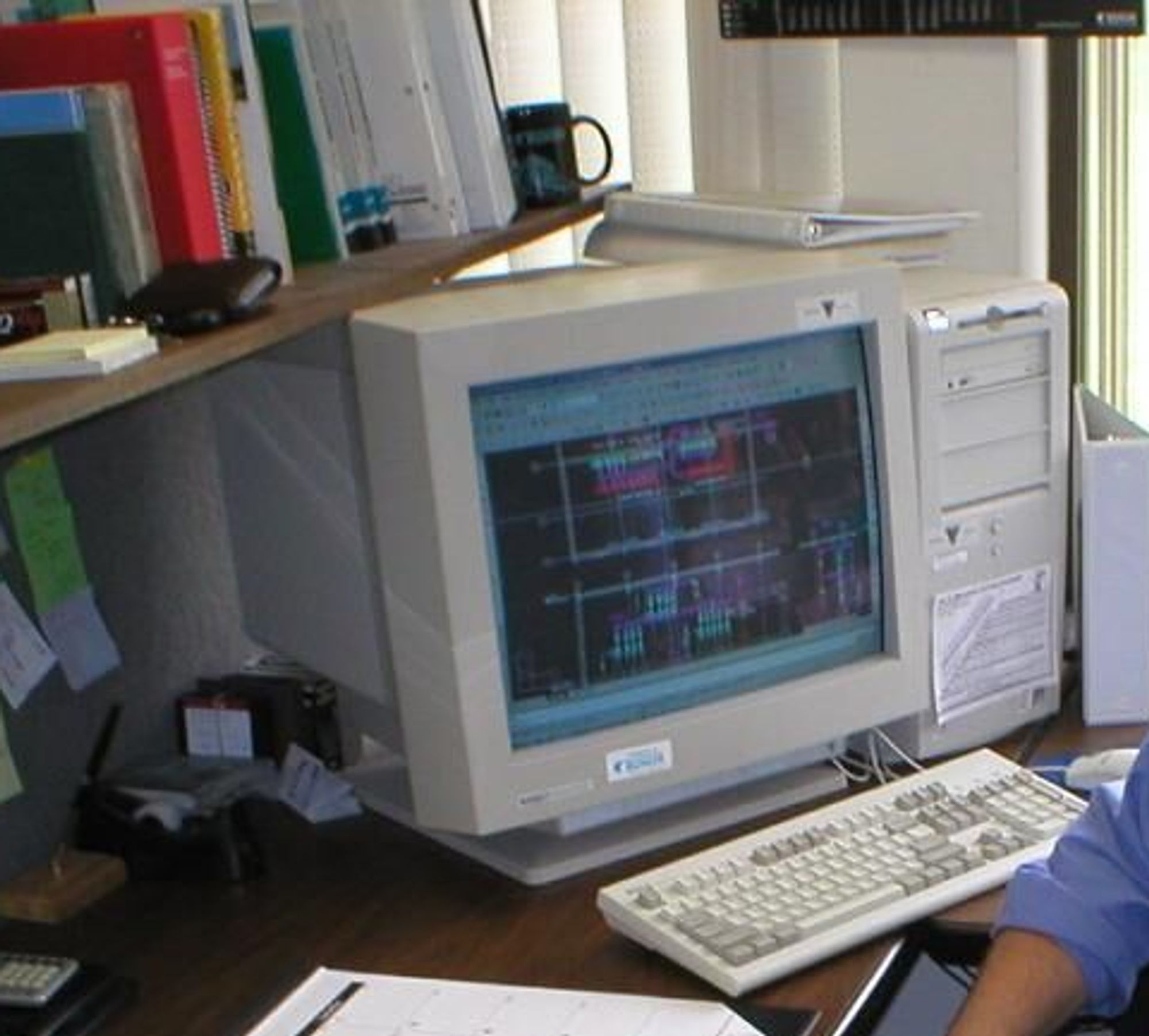 Mark Shervey in the office with an old computer.